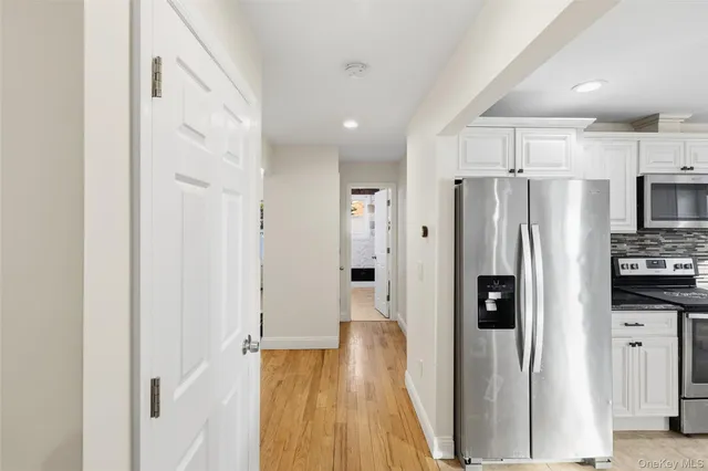 a kitchen with kitchen island granite countertop a stove a sink a refrigerator a center island and cabinets