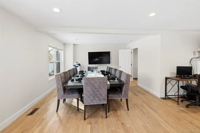 a bed room with a bed and a flat tv screen on a dresser