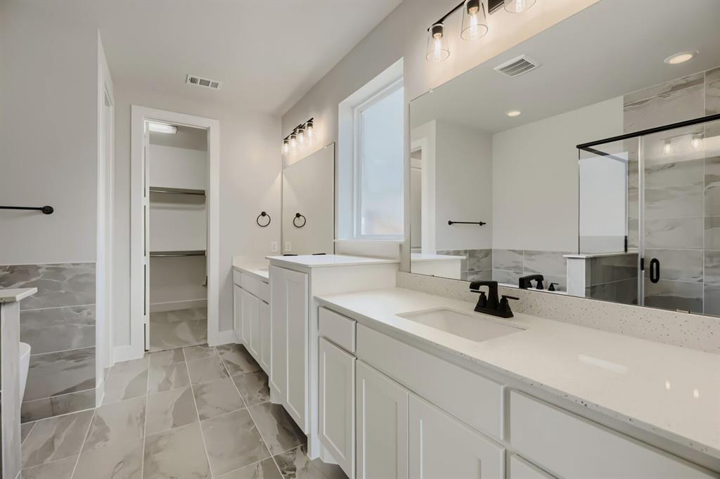 4414 Windy Point Road Oak Point, TX 75068 - Photo 14 of 27 a bathroom with a sink double vanity and mirror