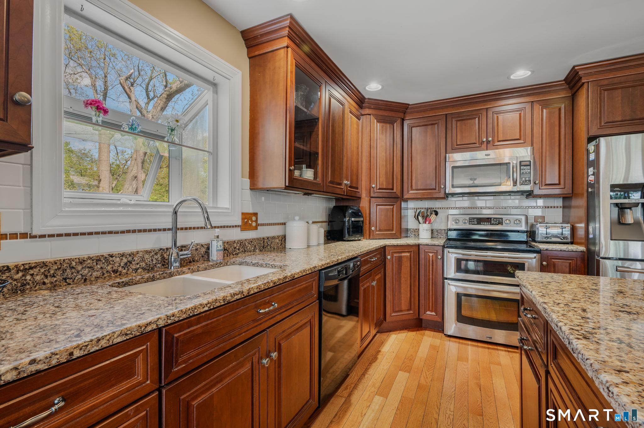 212 R Shore Road Waterford, CT 06385 - Photo 15 of 28 a kitchen with stainless steel appliances granite countertop a stove sink and cabinets