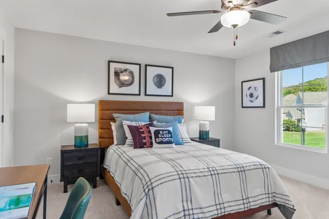 a bedroom with a bed and a window