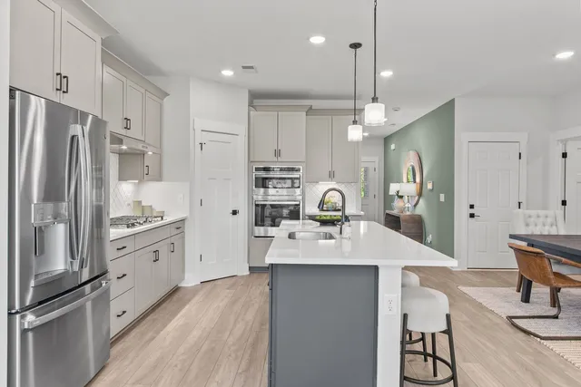 a large kitchen with cabinets and stainless steel appliances