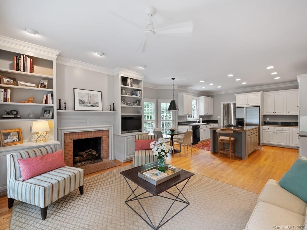 2440 Overhill Road Charlotte, NC 28211 - Photo 14 of 48 a living room with furniture kitchen view and a fireplace