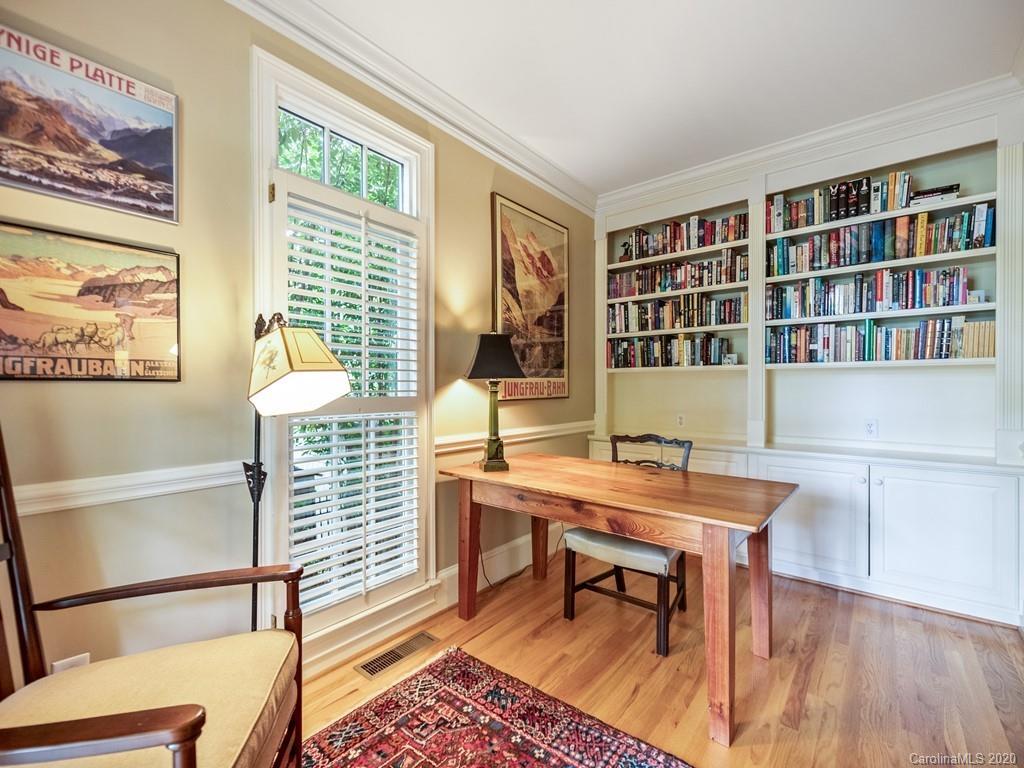 2440 Overhill Road Charlotte, NC 28211 - Photo 9 of 48 a view of a workspace with furniture and a bookshelf