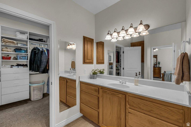 841 1010 S Street St. George, UT 84790 - Photo 14 of 33 Bathroom featuring vanity, a spacious closet, and light colored carpet