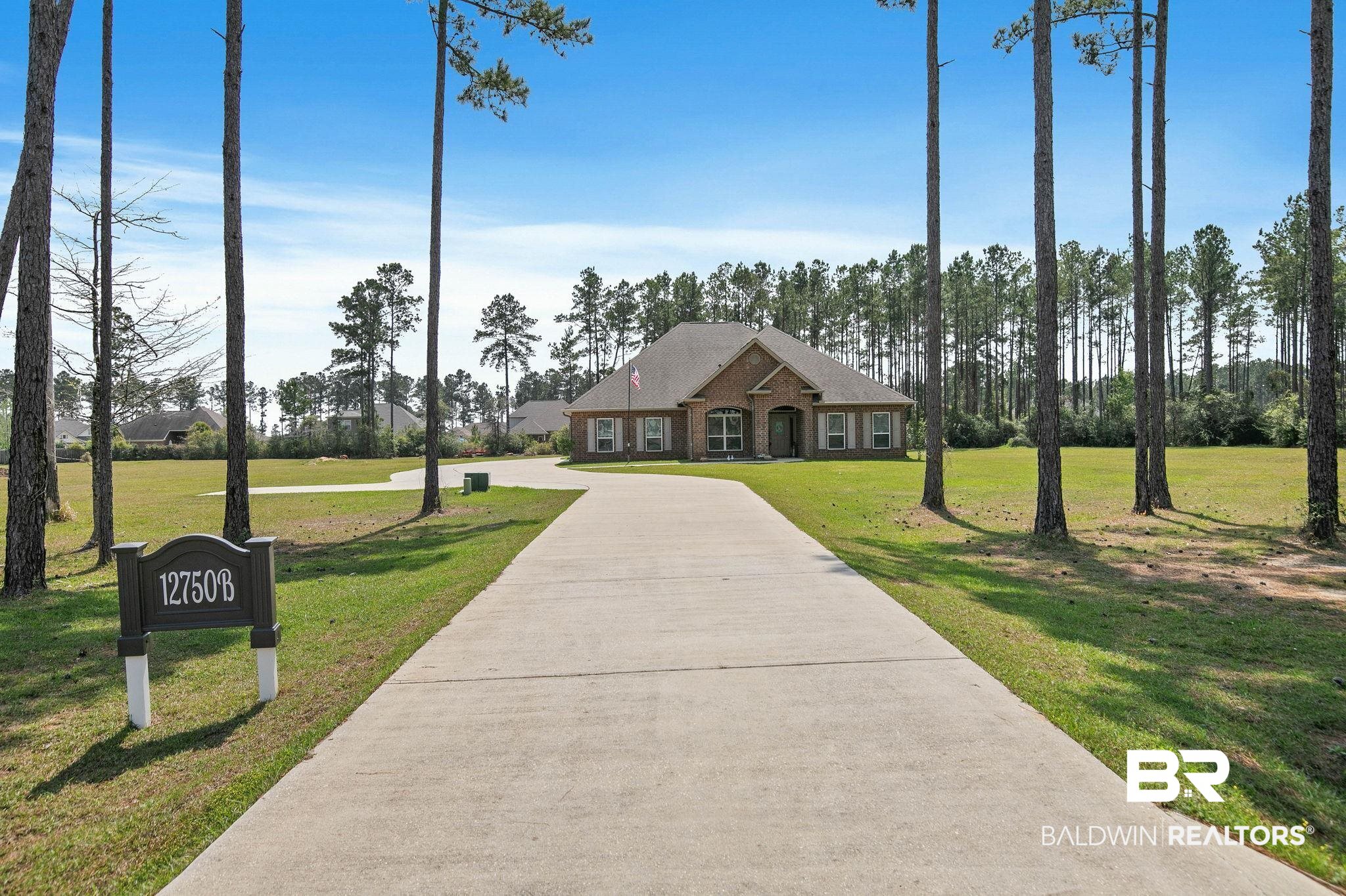 12750 B Jenkins Pit Road Daphne, AL 36527 - Photo 2 of 89 View of front of house with a front lawn, brick siding, and concrete driveway