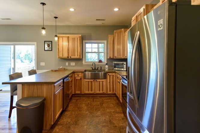 1754 Vesta Road Lebanon, TN 37090 - Photo 12 of 37 a kitchen with stainless steel appliances granite countertop a refrigerator a sink dishwasher a stove and white countertops with wooden floor