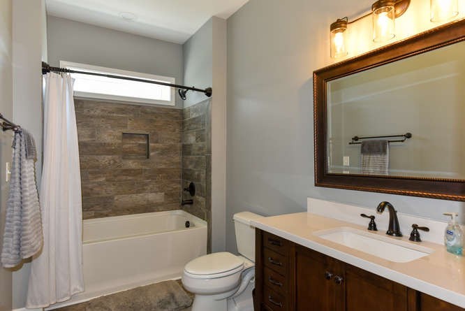 1754 Vesta Road Lebanon, TN 37090 - Photo 16 of 37 a bathroom with a bathtub shower sink vanity mirror and toilet