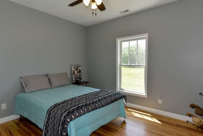 1754 Vesta Road Lebanon, TN 37090 - Photo 17 of 37 a bed sitting in a bedroom next to a window