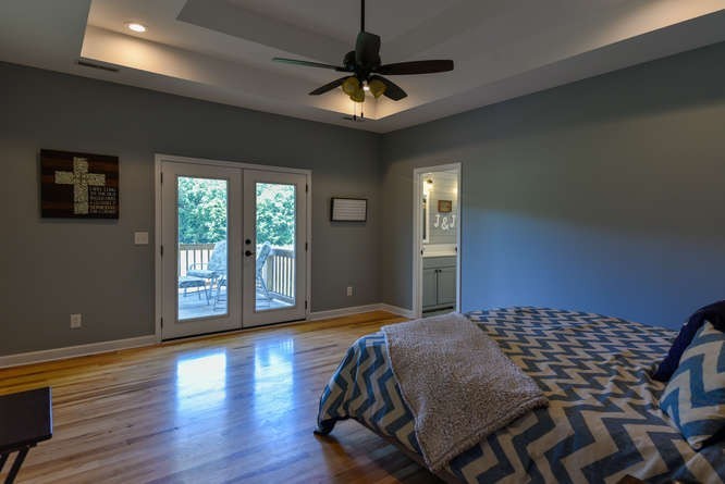 1754 Vesta Road Lebanon, TN 37090 - Photo 19 of 37 a bedroom with a bed and a chandelier