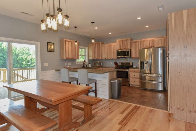 1754 Vesta Road Lebanon, TN 37090 - Photo 10 of 37 a kitchen with stainless steel appliances a table chairs refrigerator and stove