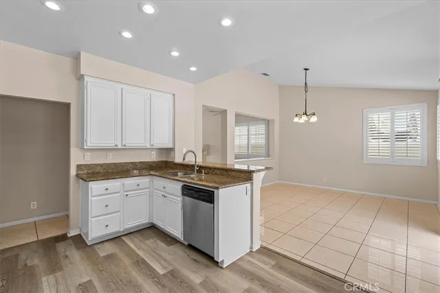 a kitchen with granite countertop appliances cabinets and a sink