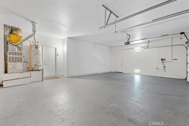 a view of backyard with large trees and plants