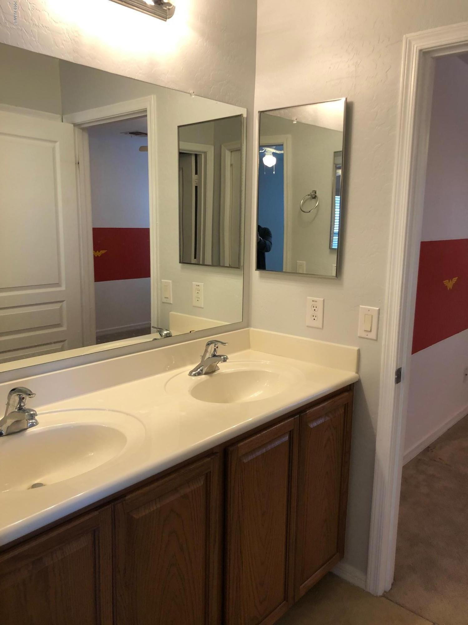 16741 West Tether Trail Surprise, AZ 85387 - Photo 14 of 20 a bathroom with a sink and a mirror