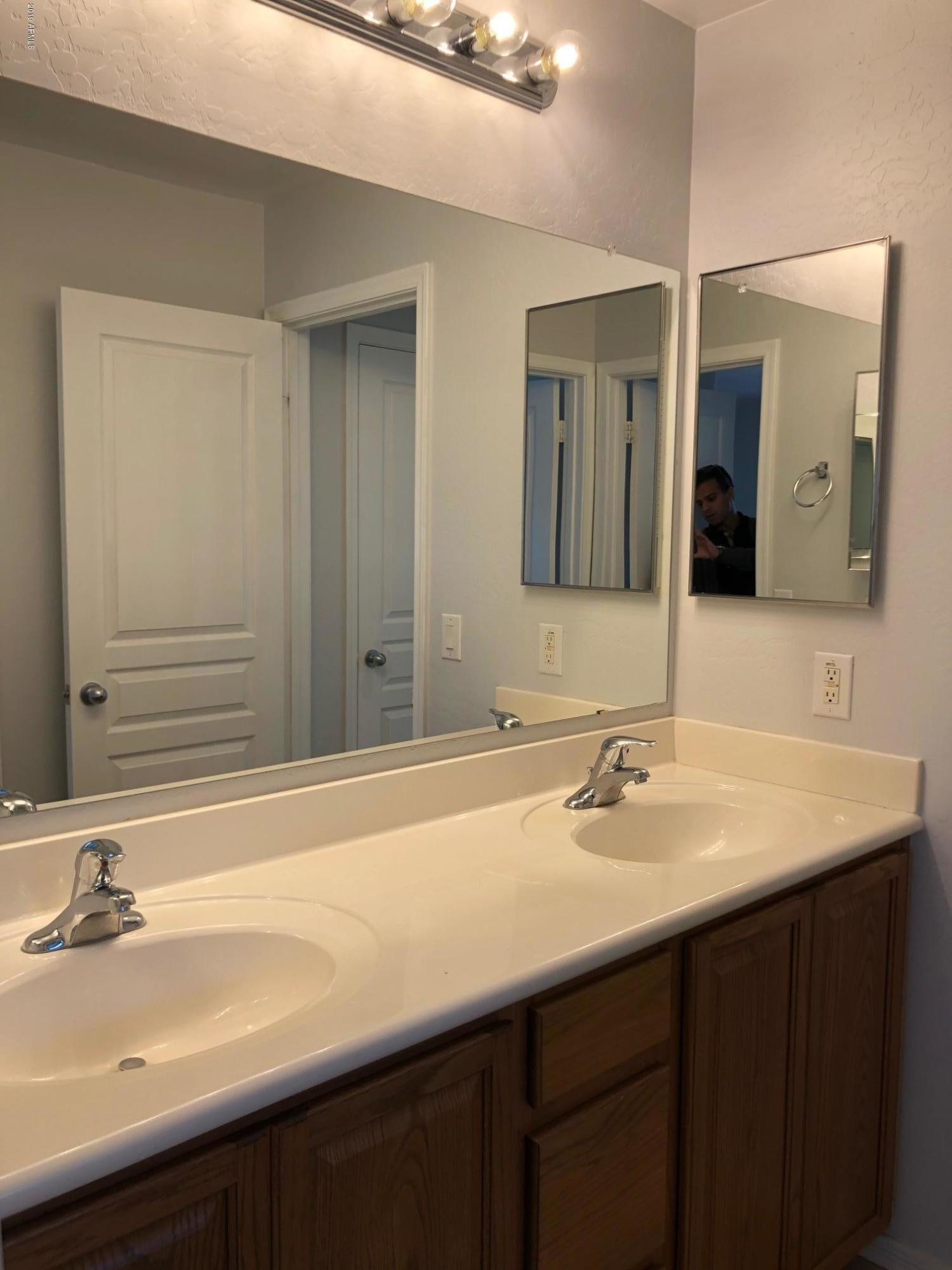 16741 West Tether Trail Surprise, AZ 85387 - Photo 17 of 20 a bathroom with a sink and a mirror