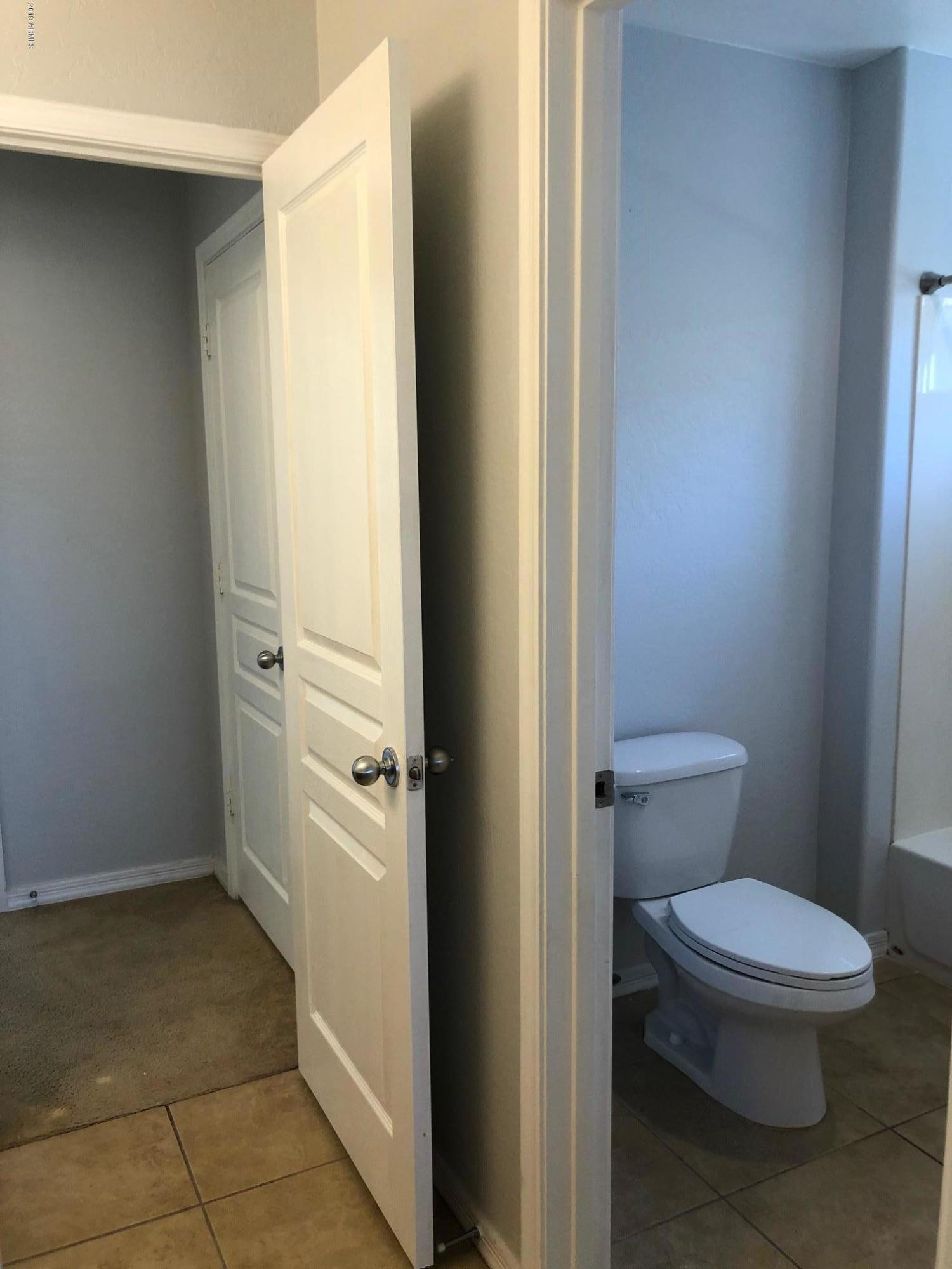 16741 West Tether Trail Surprise, AZ 85387 - Photo 18 of 20 a white toilet sitting next to a bathroom sink