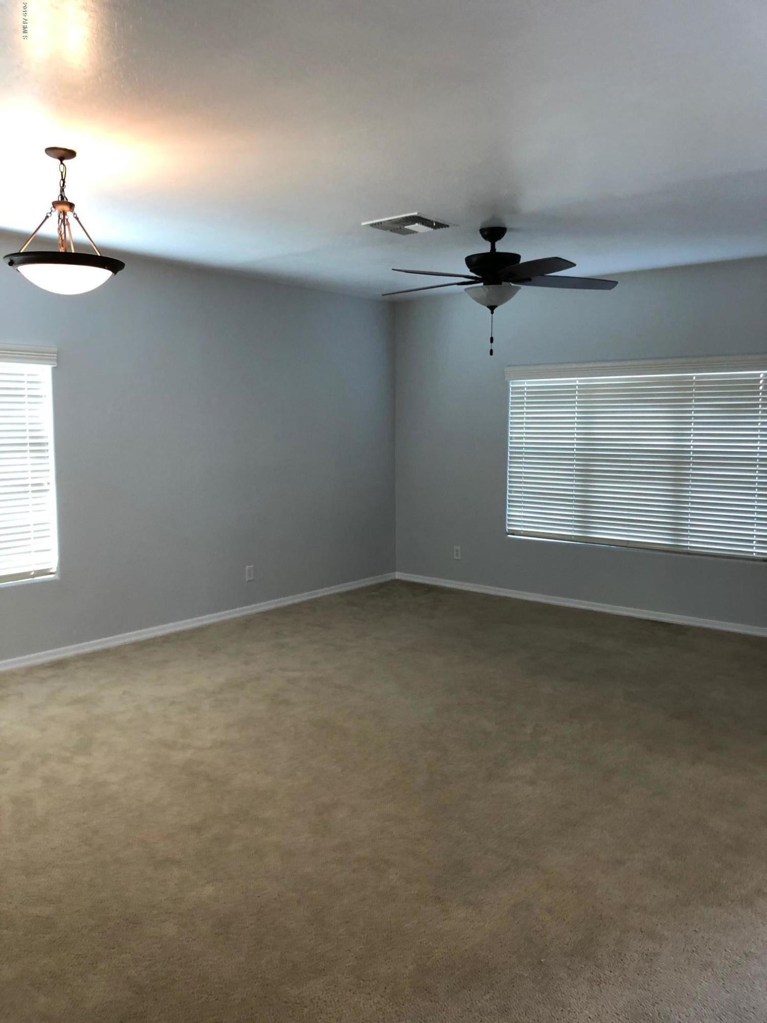 16741 West Tether Trail Surprise, AZ 85387 - Photo 7 of 20 an empty room with windows and fan