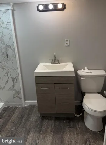 a bathroom with a sink toilet and a vanity