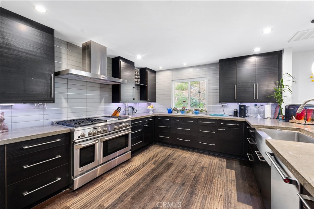 2631 Big Wagon Road Alpine, CA 91901 - Photo 18 of 49 a kitchen with wooden floors and stainless steel appliances