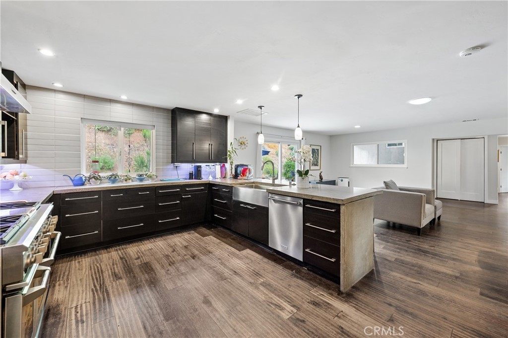 2631 Big Wagon Road Alpine, CA 91901 - Photo 19 of 49 a kitchen with stainless steel appliances kitchen island granite countertop a stove a sink and a wooden floors