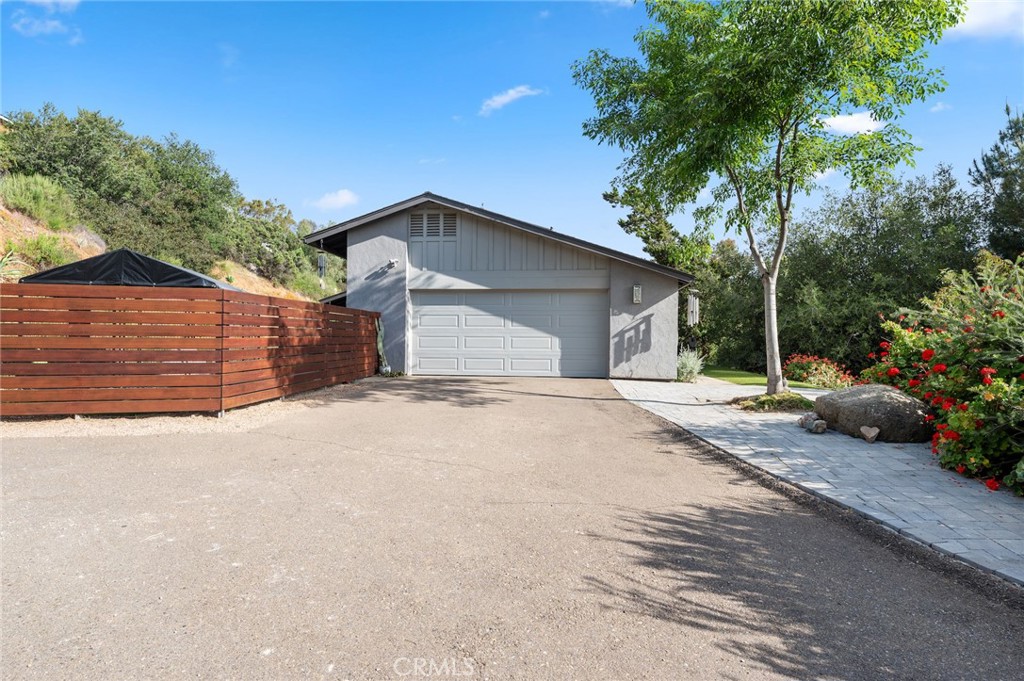 2631 Big Wagon Road Alpine, CA 91901 - Photo 2 of 49 a front view of a house with a yard and garage