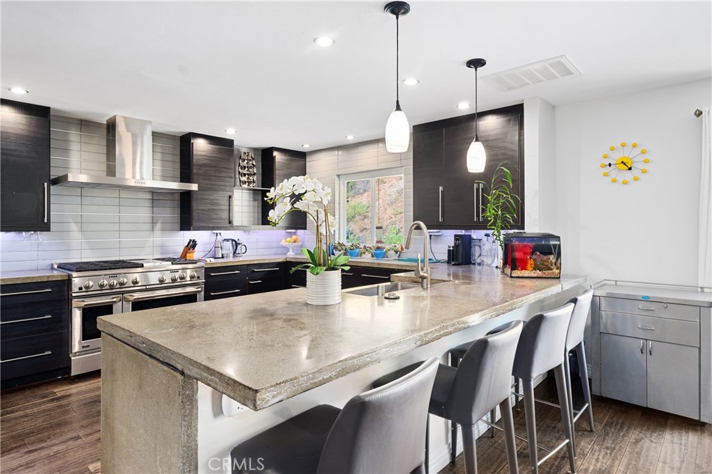 2631 Big Wagon Road Alpine, CA 91901 - Photo 21 of 49 a kitchen with a stove a counter space dining table and chairs