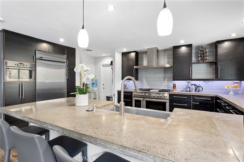 2631 Big Wagon Road Alpine, CA 91901 - Photo 22 of 49 a kitchen with stainless steel appliances granite countertop a stove a sink a refrigerator and chairs