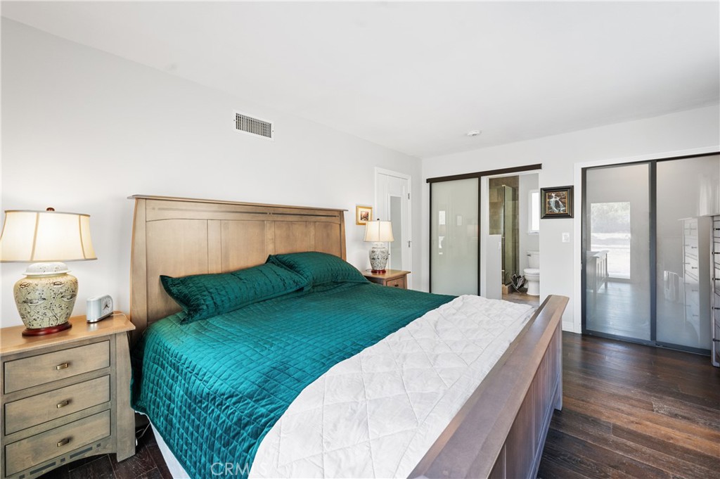 2631 Big Wagon Road Alpine, CA 91901 - Photo 33 of 49 a bedroom with a large bed and wooden floor