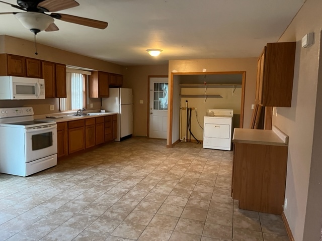 6081 South Woodlawn Road Rochelle, IL 61068 - Photo 2 of 8 a large kitchen with cabinets and stainless steel appliances