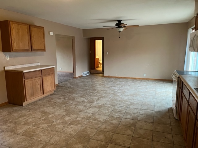 6081 South Woodlawn Road Rochelle, IL 61068 - Photo 3 of 8 a view of an empty room with a fireplace and a window