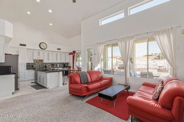 a living room with furniture a dining table and a potted plant