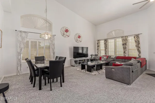 a view of a dining room with furniture and chandelier