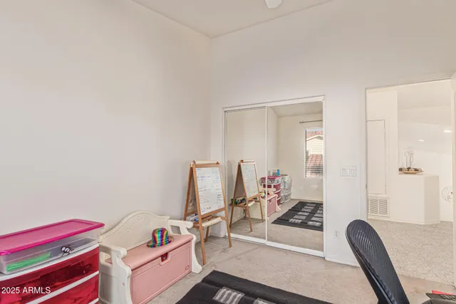 a kitchen with a table chairs and refrigerator