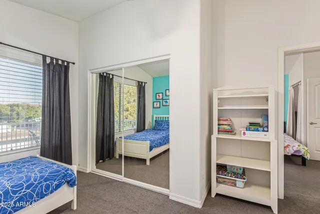 a kitchen with stainless steel appliances kitchen island granite countertop a table chairs in it and wooden floors