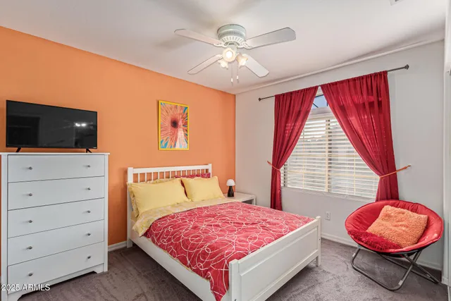 a bedroom with two beds and a chandelier