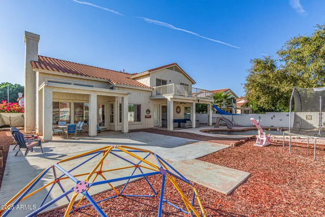 a living room with patio furniture and a floor to ceiling window