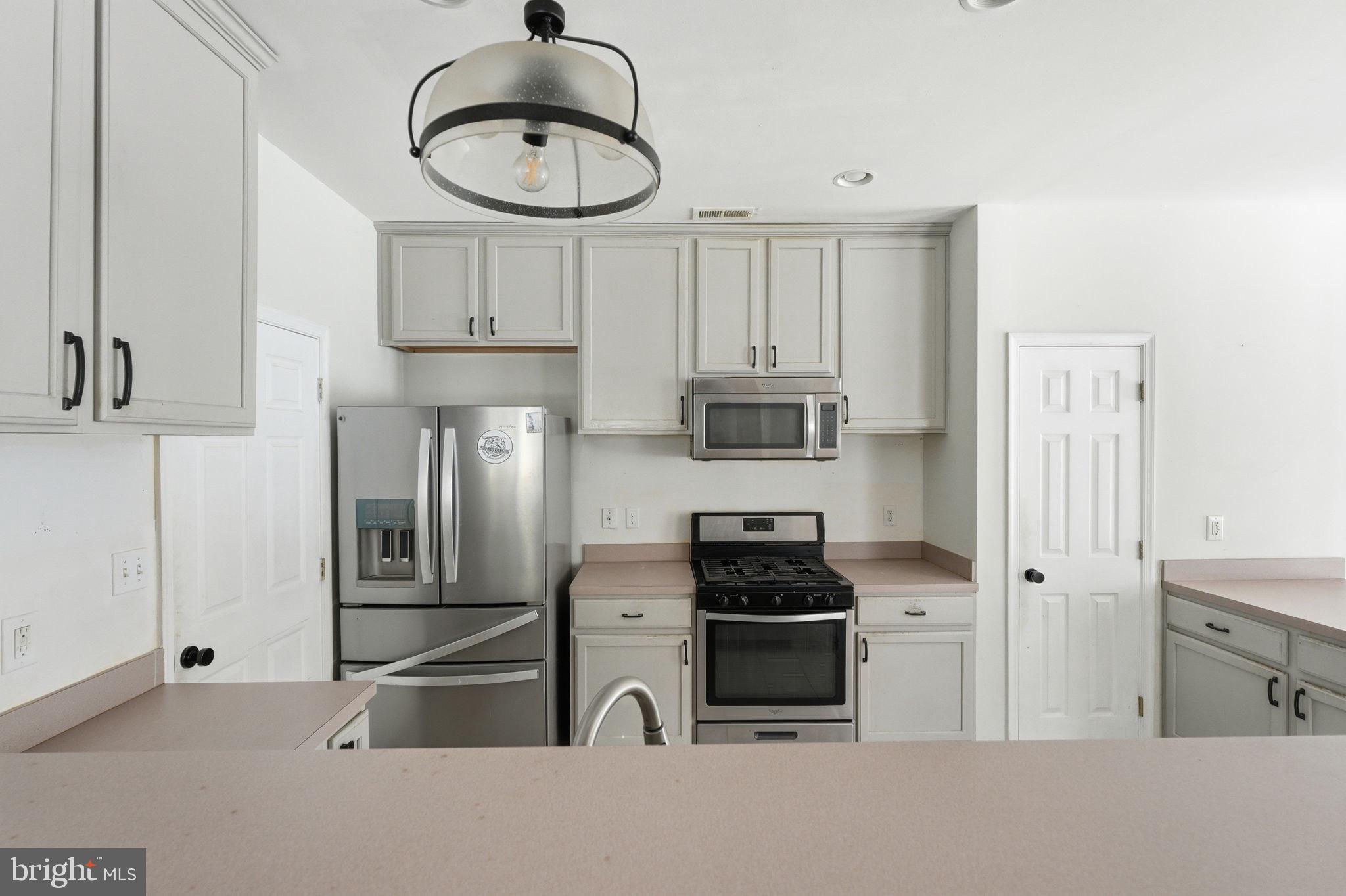 187 Gillespie Avenue Middletown, DE 19709 - Photo 11 of 43 a kitchen with stainless steel appliances a refrigerator sink and cabinets