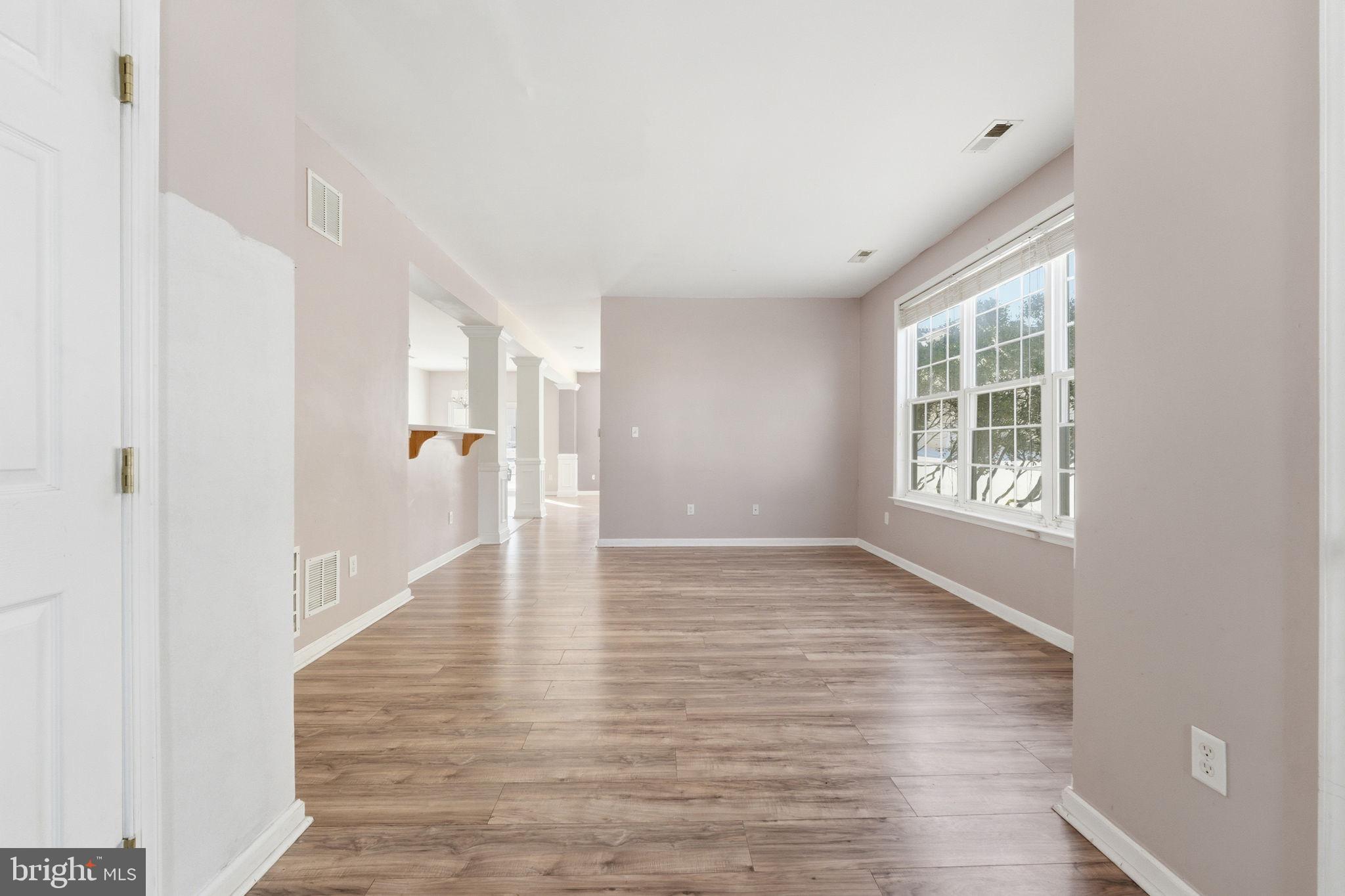 187 Gillespie Avenue Middletown, DE 19709 - Photo 4 of 43 a view of an empty room with wooden floor and a window