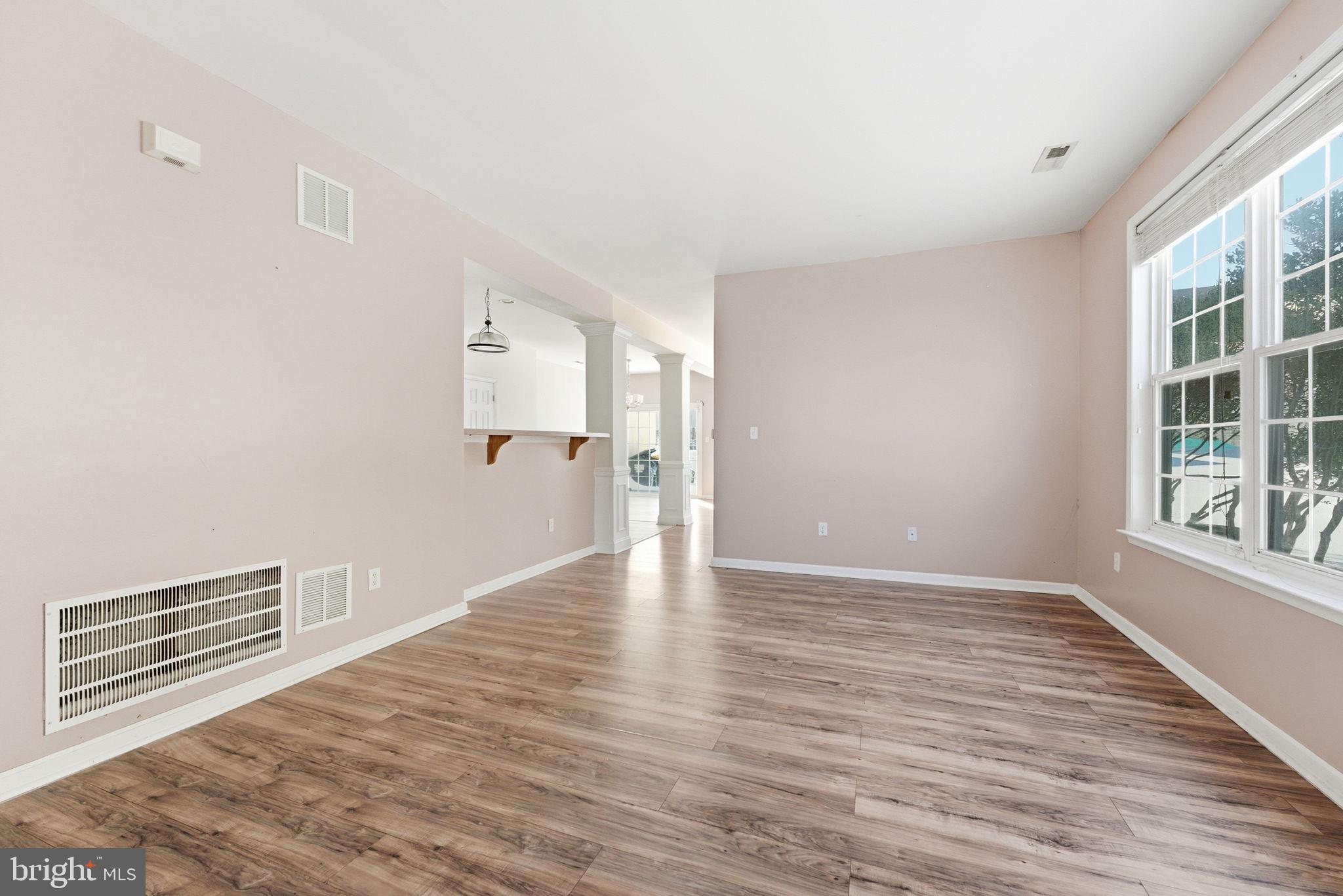 187 Gillespie Avenue Middletown, DE 19709 - Photo 5 of 43 a view of an empty room with wooden floor and a window