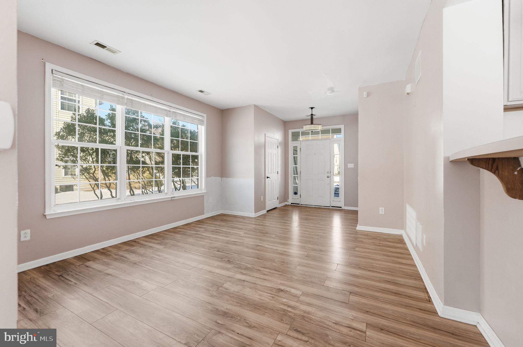 187 Gillespie Avenue Middletown, DE 19709 - Photo 6 of 43 a view of an empty room with wooden floor and a window
