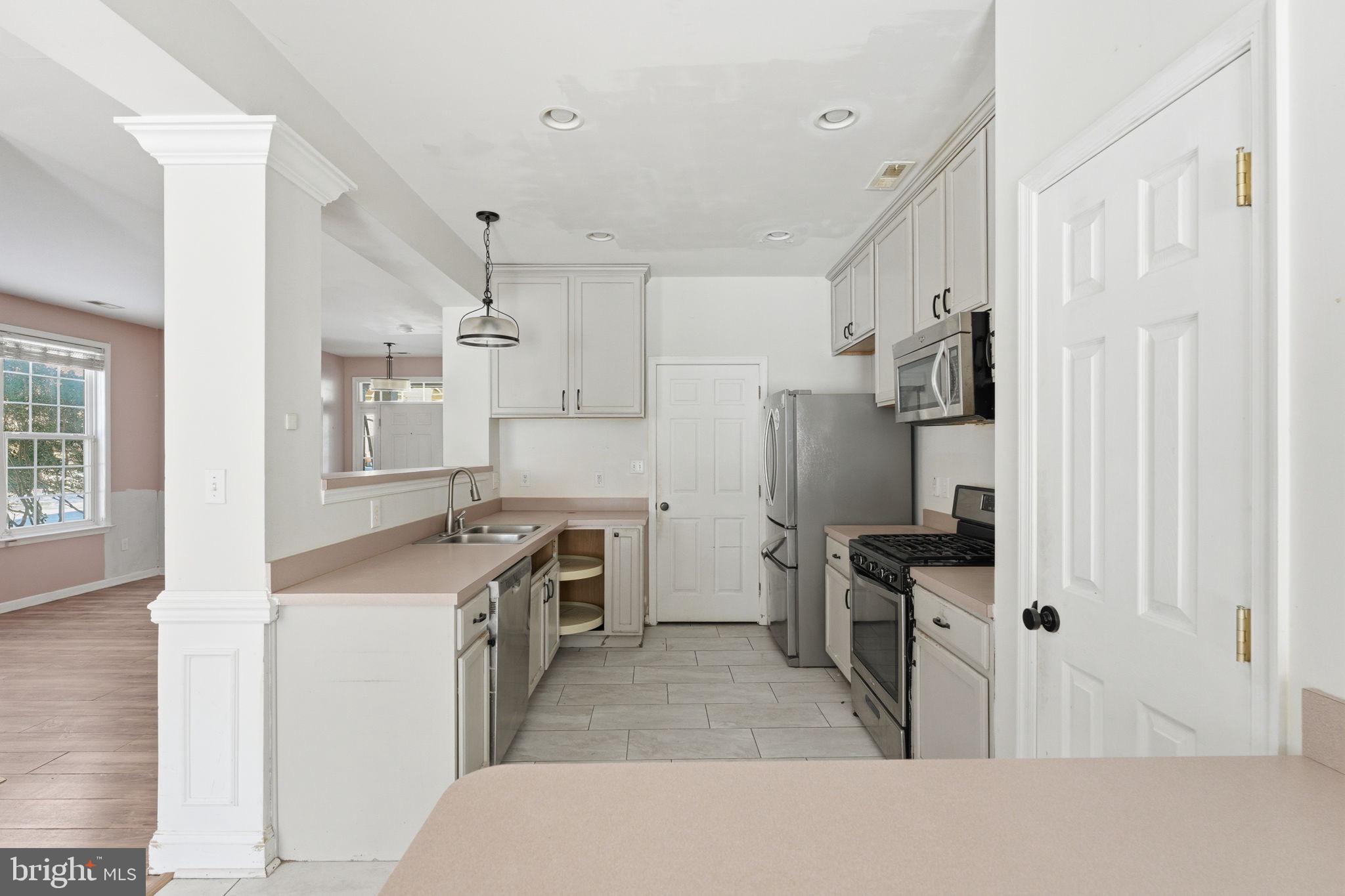 187 Gillespie Avenue Middletown, DE 19709 - Photo 8 of 43 a kitchen with stainless steel appliances granite countertop a sink stove and refrigerator