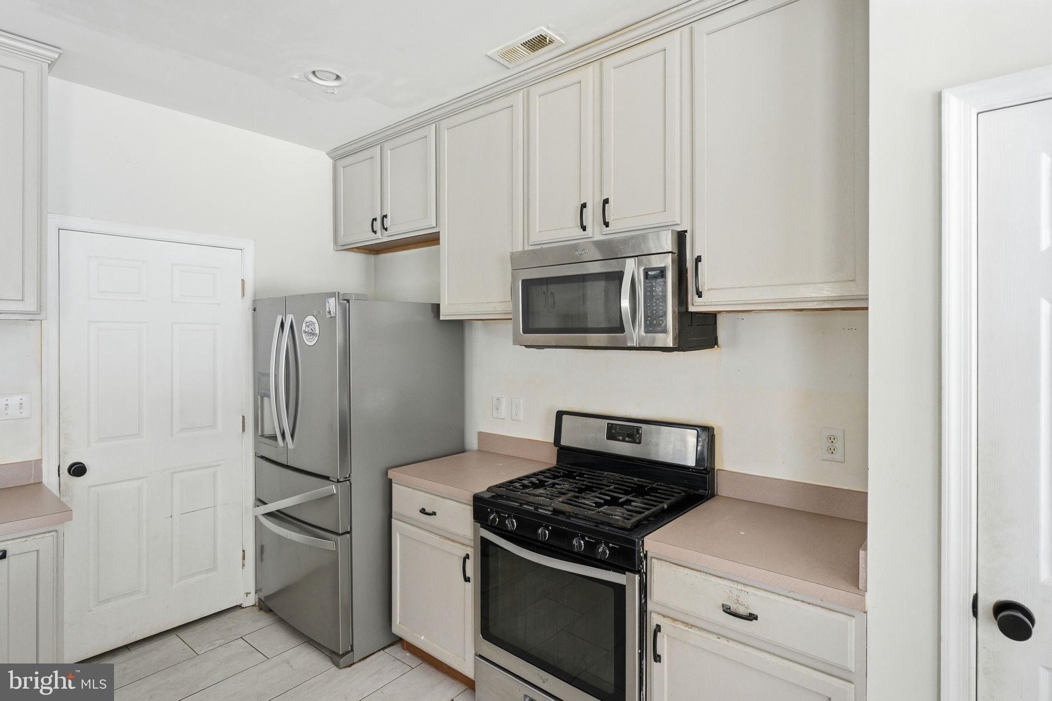 187 Gillespie Avenue Middletown, DE 19709 - Photo 10 of 43 a kitchen with white cabinets and stainless steel appliances