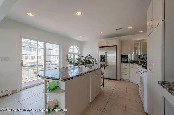 a kitchen with refrigerator and cabinets