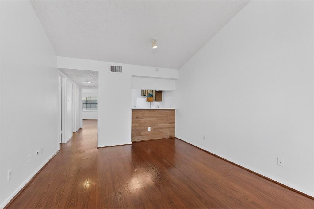 8545 Midpark Road, Unit 16 Dallas, TX 75240 - Photo 5 of 29 Unfurnished bedroom featuring dark wood-style floors and lofted ceiling
