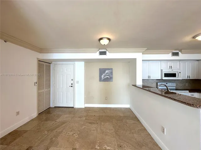 a kitchen with stainless steel appliances granite countertop a sink and cabinets