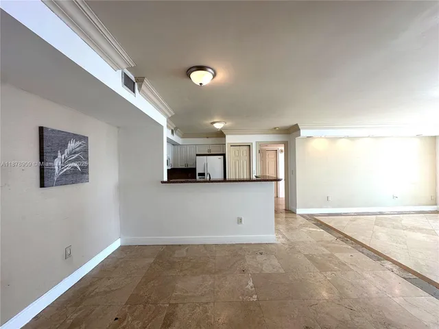 a view of a big room with wooden floor and windows