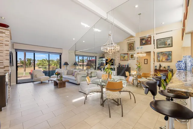 a bathroom with a granite countertop sink a toilet and a mirror