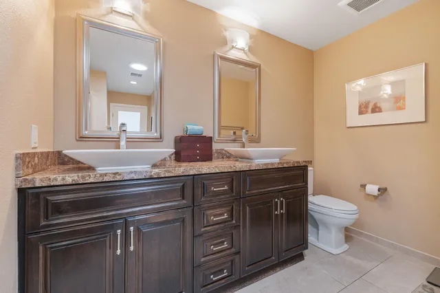 a bathroom with a sink a toilet and a mirror