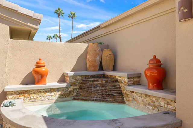 a dining room with furniture a potted plant and a chandelier