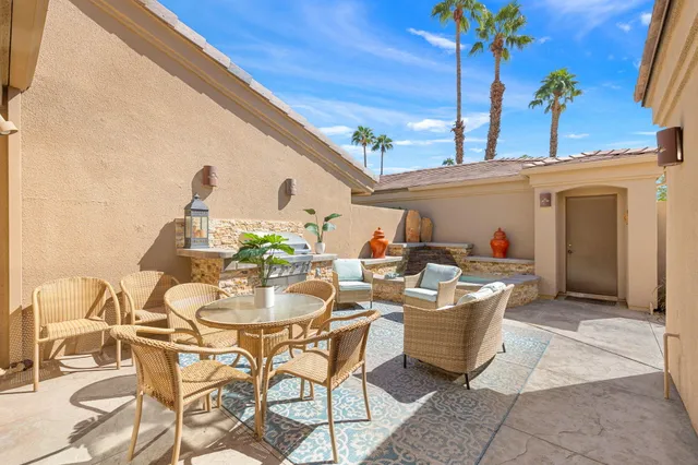 a kitchen with stainless steel appliances granite countertop a sink counter space cabinets and a stove